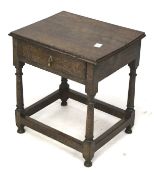 An oak side table with a single drawer. On turned supports with square stretchers.
