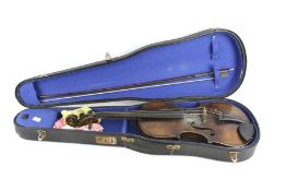 A vintage violin, bow and case.