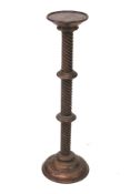 A turned wooden torchiere stand.