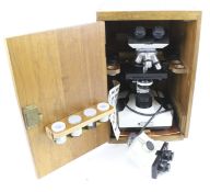 A CE microscope with two interchangeable binocular eyepieces.