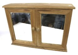 A contemporary pine bathroom mirror wall cabinet.