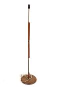 A mid-century retro standard lamp. Of brass and wood construction on a circular base.