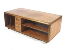 A mid-century teak entertainment centre TV/hi-fi stand on wheels.