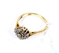 A modern 9ct gold and diamond cluster ring. The 23 round brilliants circa 0.