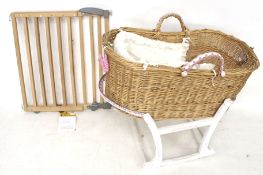 A babies Mosses basket on stand.