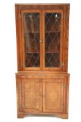 A carved oak corner display cabinet.