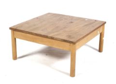 A mid-century Ercol '602' label square coffee table. On turned supports.