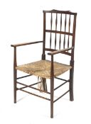 An Arts and Crafts beech open armchair.
