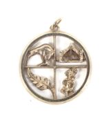 A vintage New Zealand gold round pendant.