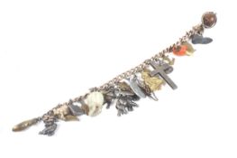 An early 20th century rose gold curb link 'charm' bracelet on a heart-shaped padlock clasp stamped