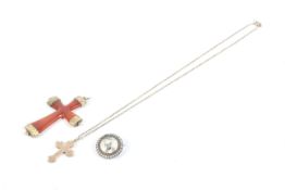 Two Victorian gold or gold mounted crosses and a gold and half-pearl small round locket brooch.