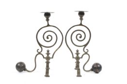 A pair of Arts and Crafts brass and copper candlesticks, in the manner of WAS Benson.