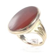 A vintage 9ct gold and carnelian oval signet ring. The plain oval carnelian approx.