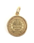 A modern high carat gold small pseudo coin pendant.