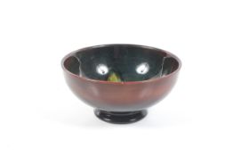 A William Moorcroft flambe bowl.