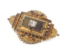 A late Victorian gold and diamond shaped-oval brooch in Etruscan style.