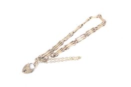 An early 20th century rose gold three-bar gate bracelet.