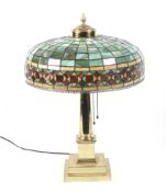 A 1922 gilded Tiffany style table lamp.