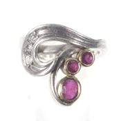 A ruby and diamond abstract leaf and scroll ring by Erica Sharpe.