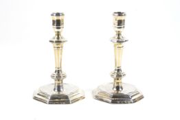 A pair of Queen Anne cast silver octagonal candlesticks.