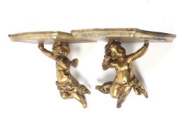 A pair of 18th/19th century gilt wood cherub wall brackets.
