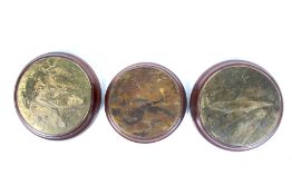 Three Trench Art brass plaques depicting WWI battle scenes.