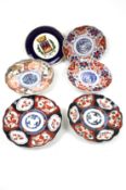 Five 20th century Japanese plates and an earlier Armorial plate.