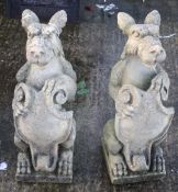 A pair of composite stone gargoyles or dragons.