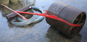A vintage cast metal lawn roller.