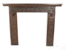 A carved oak mantle piece.