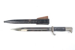 A German WWII bayonet. Marked Alcoso Solingen to blade, in a metal scabbard. L40.
