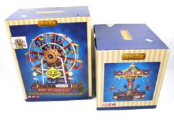 Two boxed Lemax models.