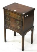 A small mahogany veneered unit. With three drawers, H69cm x W44.5cm x D30.