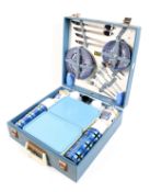 A mid-century Brexton picnic hamper. With china cups, saucers and plates, two Thermos flasks, etc.