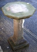 A composite stone octagonal bird bath.