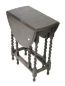 A mahogany barley twist drop leaf table. Of oval form, H72.