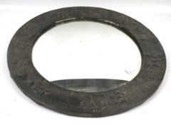 An early 20th century circular embossed pewter framed mirror.