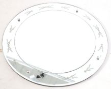 An early 20th century circular wall mirror. Having engraved border and a bevelled edge.