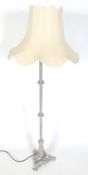 A contemporary classic tripod base standard lamp.