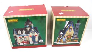 Two boxed Lemax models.