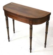 A 20th century mahogany veneered demi lune cards table.