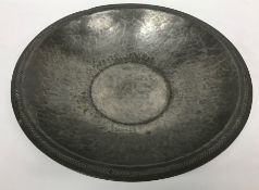 An Arts & Crafts pewter bowl with chevron decoration to the rim and centre inscribed 