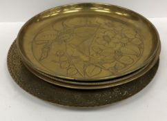 A collection of four brass trays, one in the Art Nouveau manner stamped 