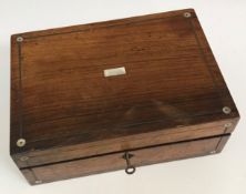 A Victorian mahogany and inlaid workbox opening to reveal various sewing accoutrements to include