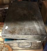A tin trunk, the handles inscribed 