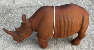 A cast metal figure of a rhinoceros, with rust style patination, 43 cm long