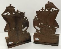 A pair of carved teak 
