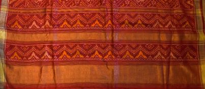India - Patola with Gold Border handmade in red with a decorative pattern, a modern cloth in an