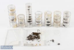 A collection of round stacking containers with hooks from size 18 to 6, and a box of mixed hooks, up