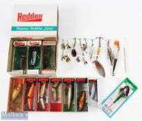 A collection of lures made up of: 4x Heddon plugs in original packs; 6x Rapala lures (3 jointed)